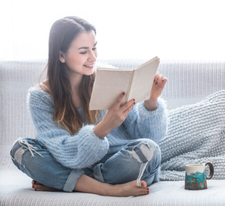 woman reading on couch